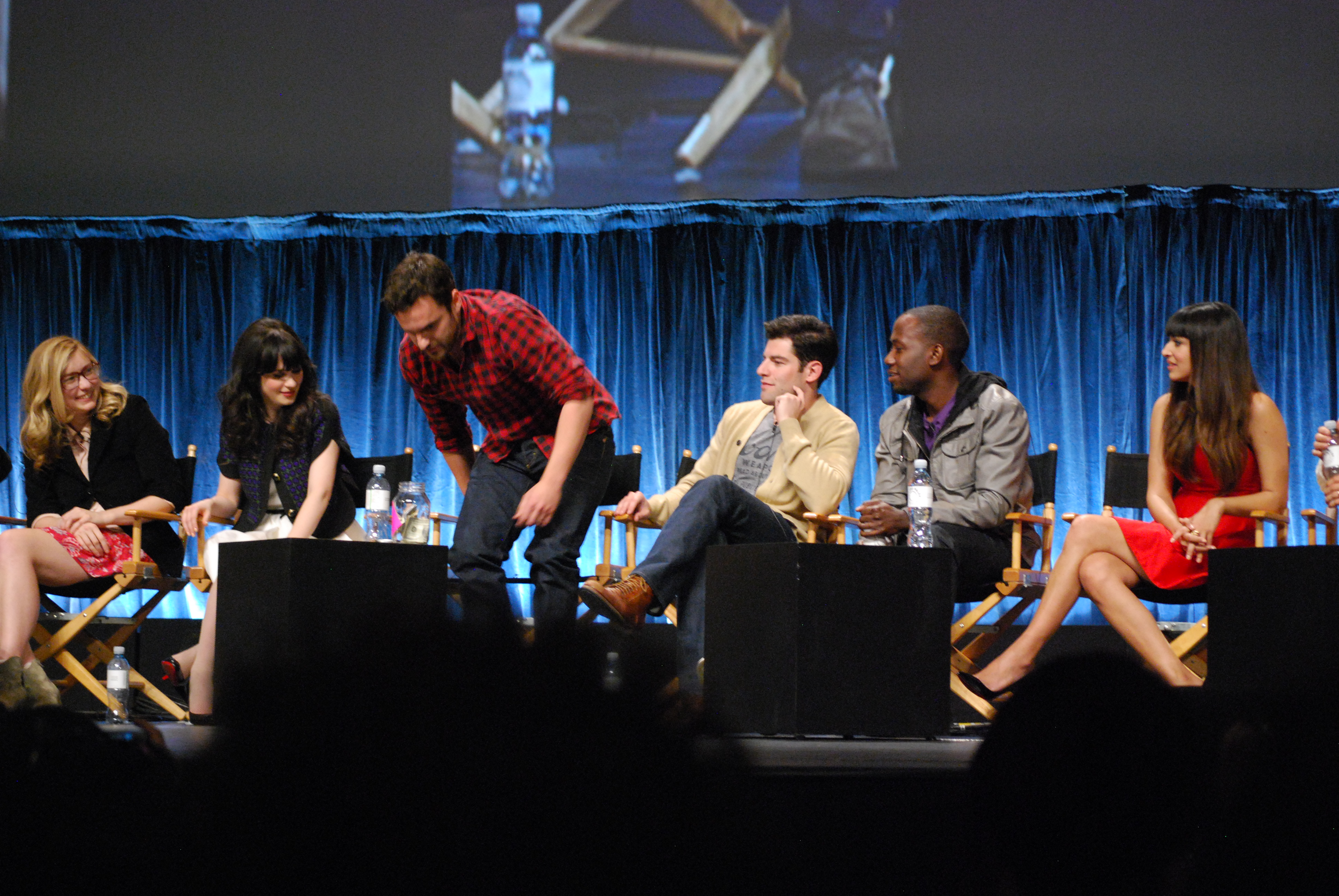 New Girl creator Elizabeth Meriwether and cast members Zooey Deschanel, Jake Johnson, Max Greenfield, Lamorne Morris and Hannah Simone onstage at PaleyFest in March 2012.
