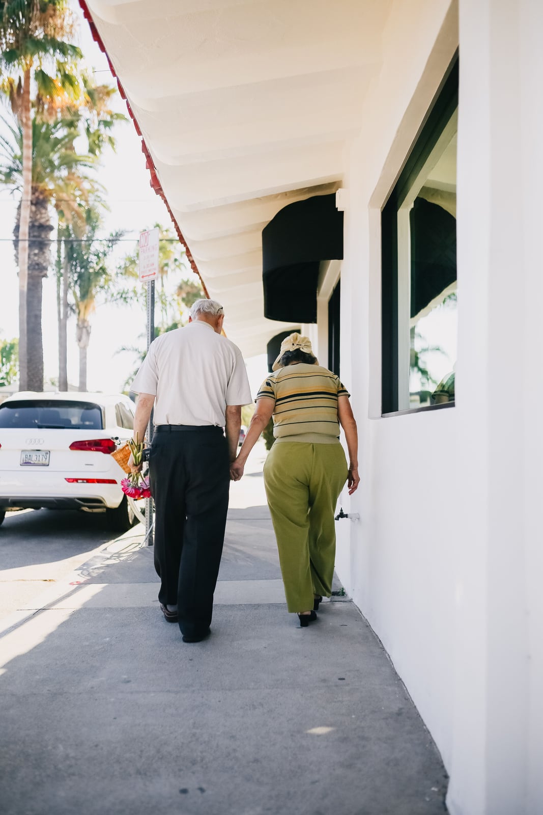 An older couple walking together in an illustrative photograph from 2020; no participation in WHO research is implied.